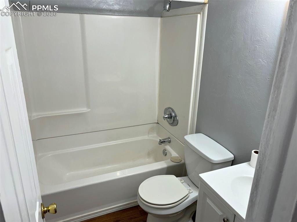 Image 4 of 17: Full bathroom featuring vanity, bathing tub / shower combination, dark wood