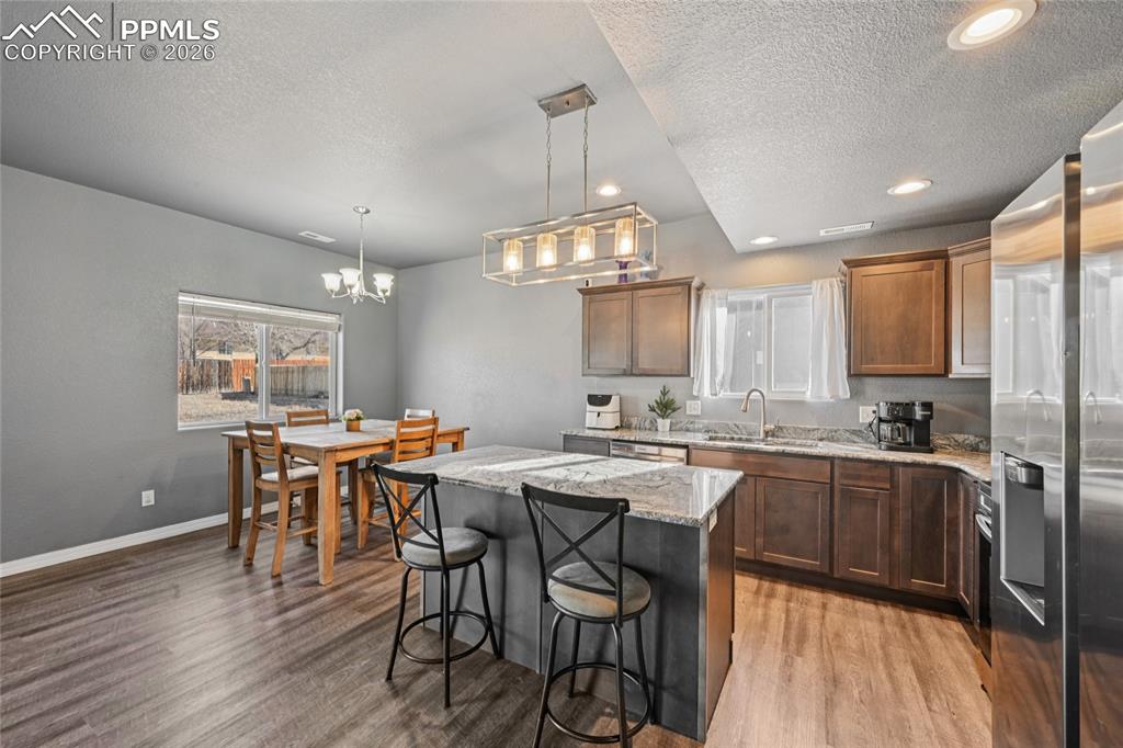 Image 17 of 42: Kithcen island and countertops are granite.