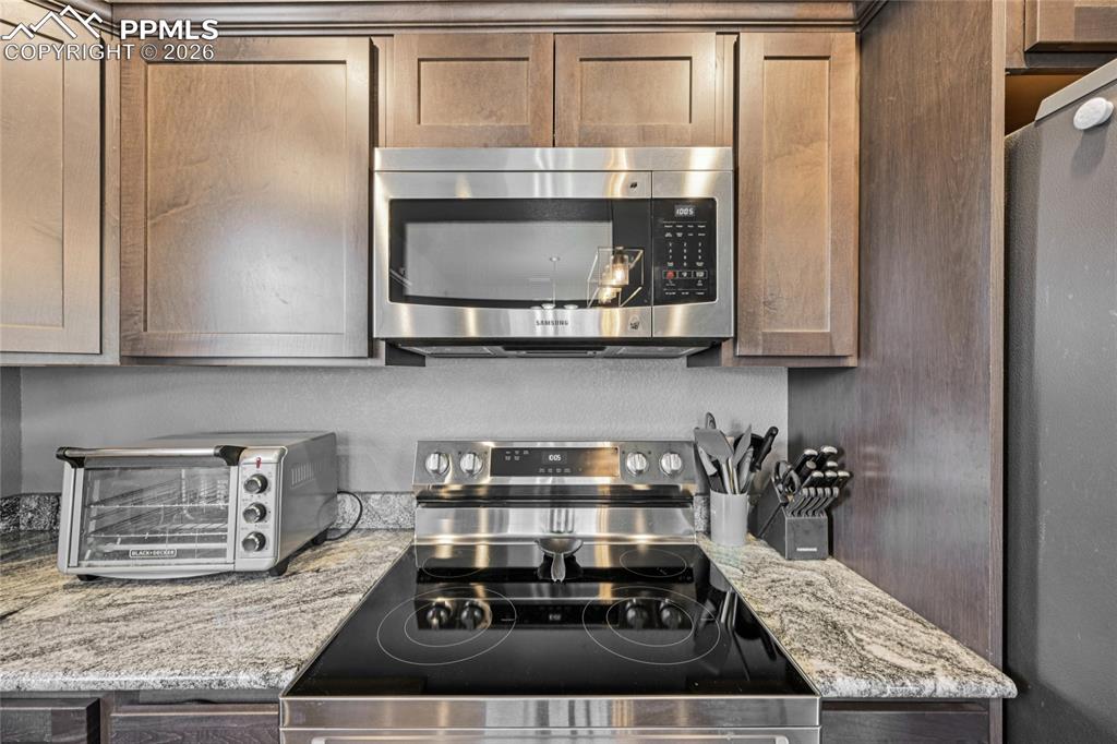 Image 22 of 42: Stainless steel appliances stay with kitchen.
