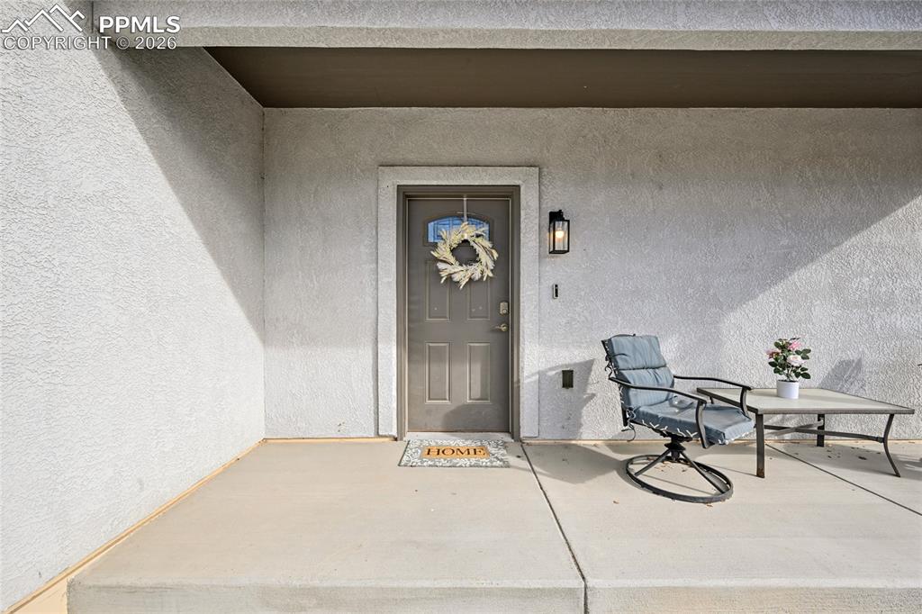 Image 6 of 42: A wide front porch greets visitors. Plenty of outdoor space to visit with n