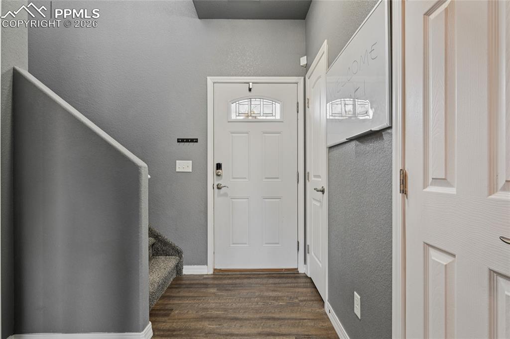 Image 9 of 42: The wide entryway provides space for a backpack drop area or coat tree.