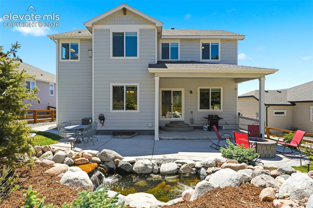 Image 37 of 44: Rear exterior featuring a covered patio, concrete patio, sliding glass door