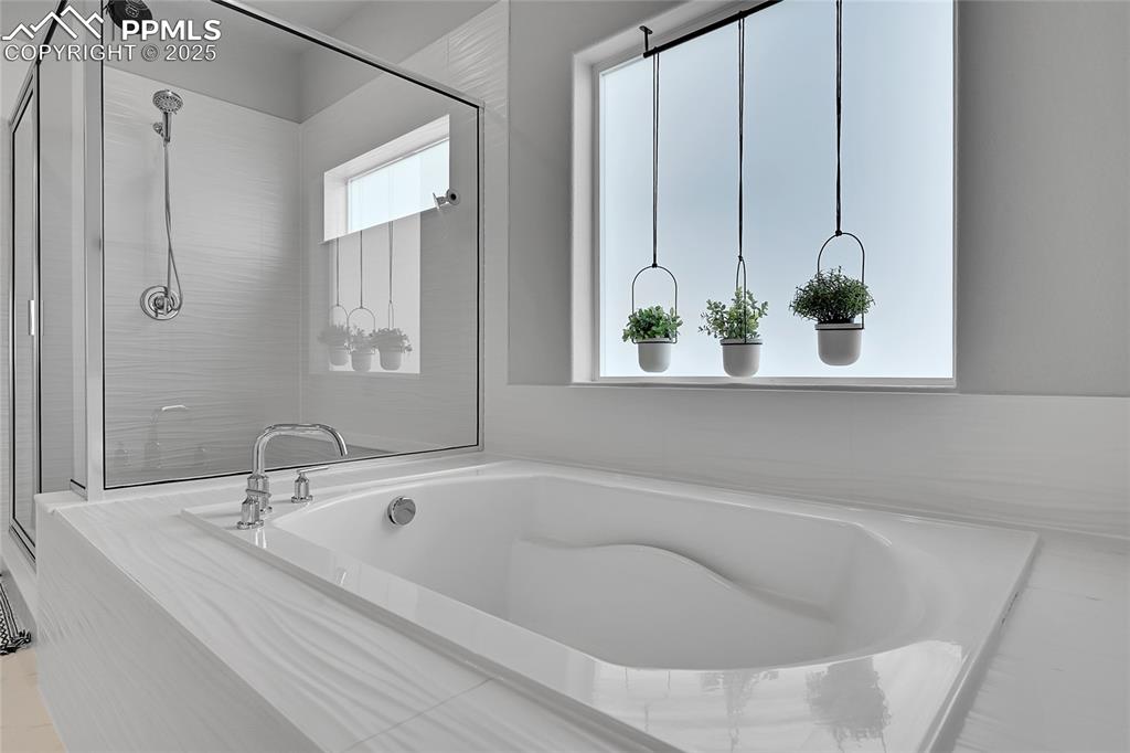 Image 12 of 44: Full bath with a bath and a stall shower