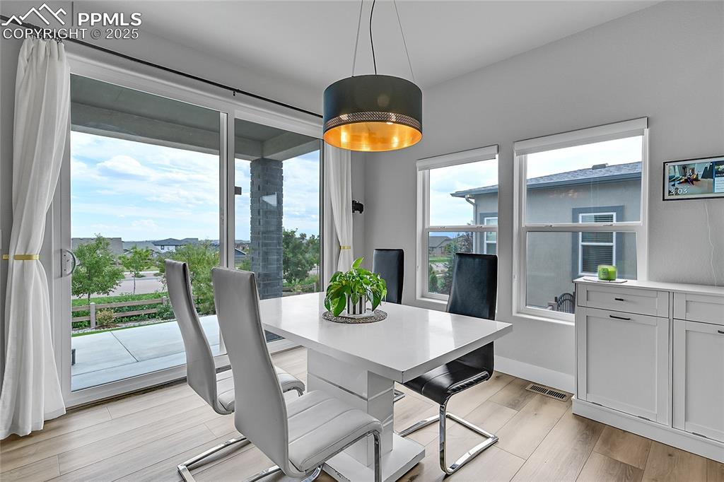 Image 13 of 44: Dining room featuring light wood-style flooring and baseboards