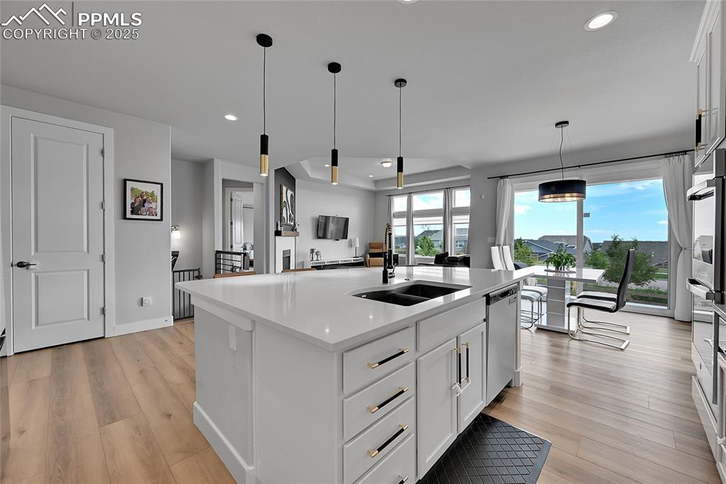 Image 2 of 44: Kitchen featuring recessed lighting, light wood finished floors, light coun