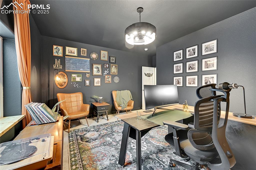 Image 21 of 44: Office area with a chandelier