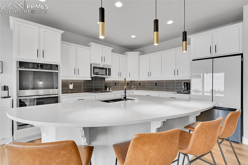 Image 3 of 44: Kitchen featuring appliances with stainless steel finishes, recessed lighti