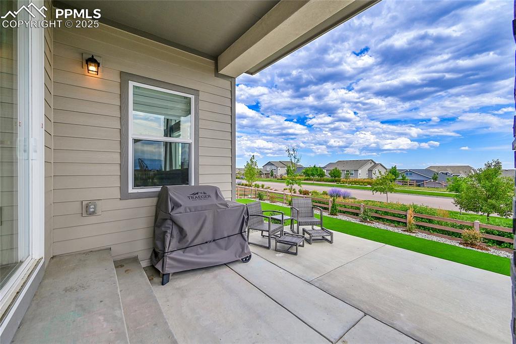 Image 34 of 44: View of patio with a grill and a residential view