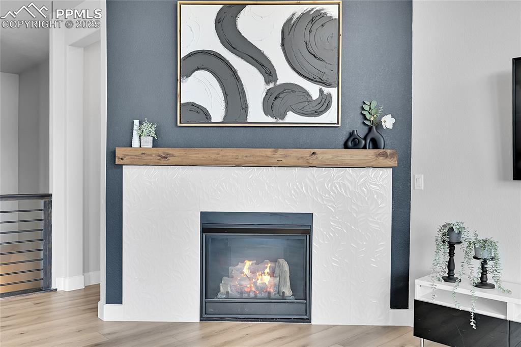 Image 6 of 44: Detailed view of wood finished floors and a glass covered fireplace