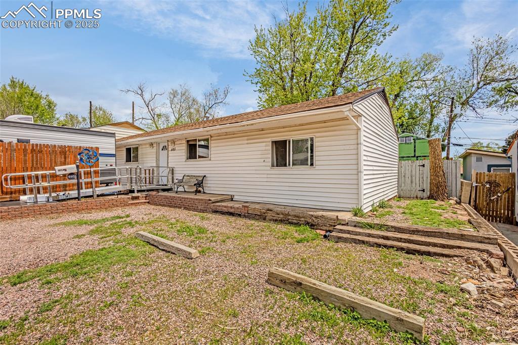 Caption: View of front of home with a fenced backyard and a deck