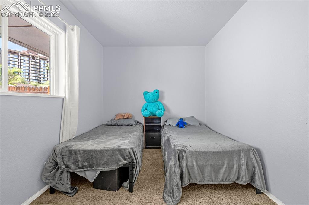 Image 10 of 30: Carpeted bedroom featuring baseboards