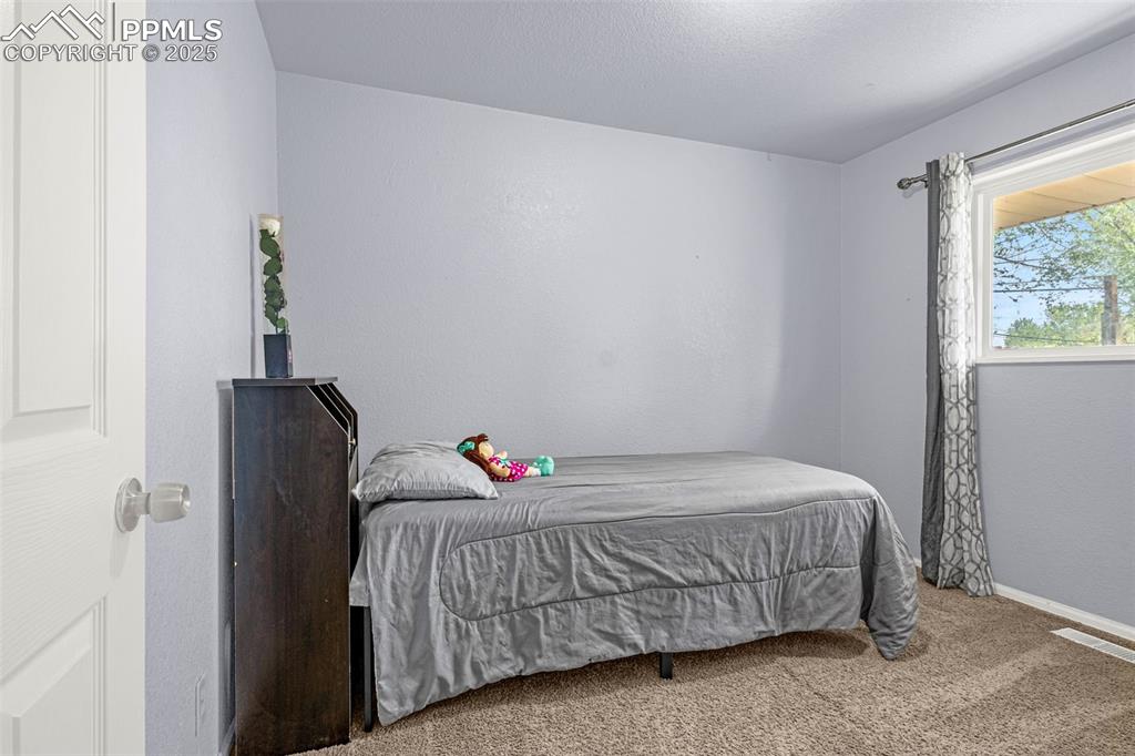 Image 11 of 30: Carpeted bedroom with baseboards