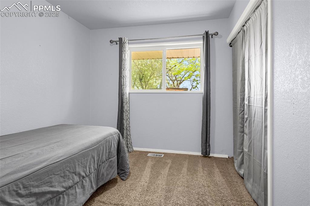 Image 12 of 30: Carpeted bedroom with baseboards