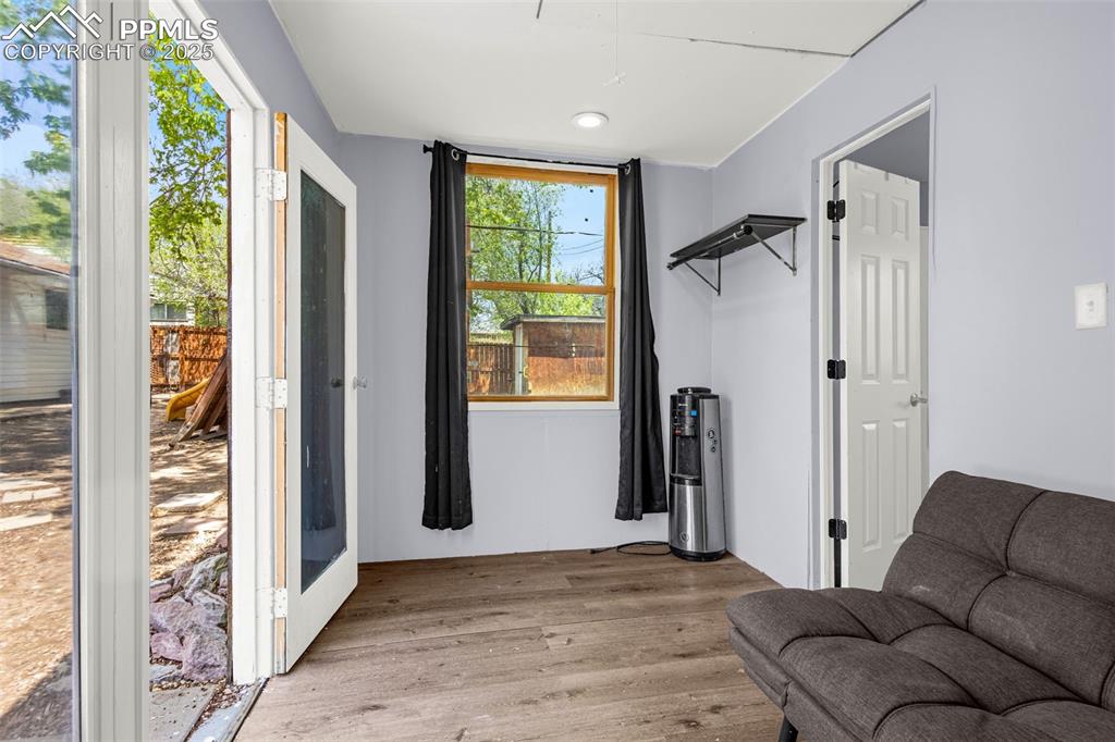 Image 18 of 30: Sitting room with light wood-type flooring and attic access