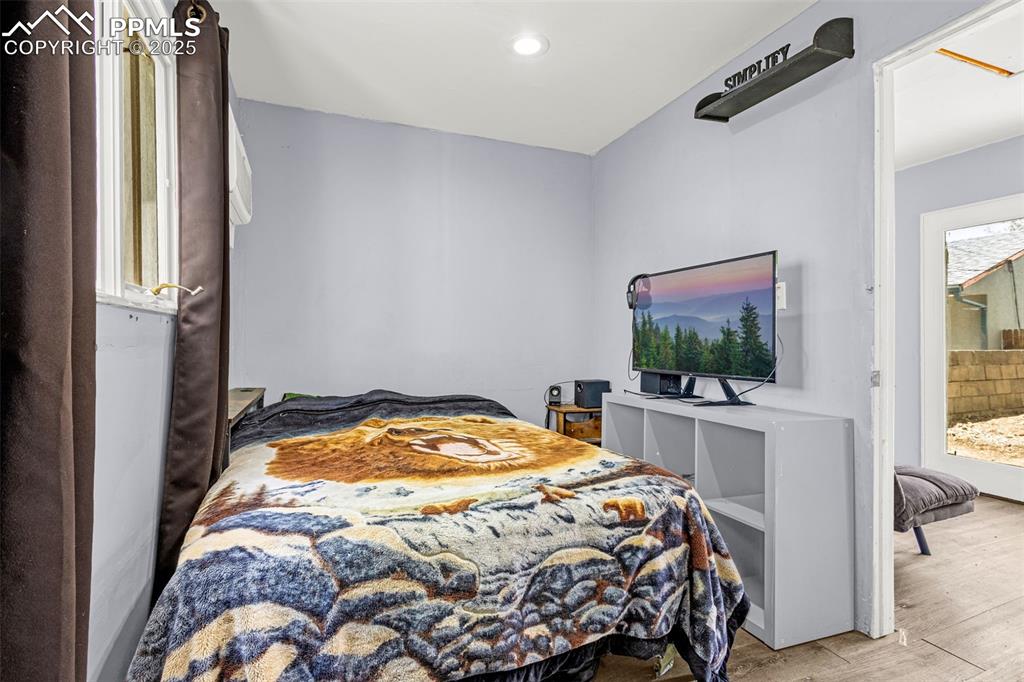 Image 19 of 30: Bedroom featuring wood finished floors and recessed lighting