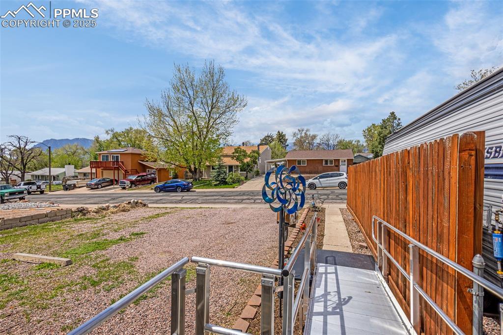 Image 8 of 30: View of yard featuring fence, a mountain view, and a residential view