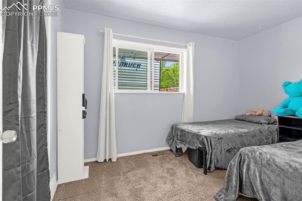 Image 9 of 30: Bedroom featuring carpet floors