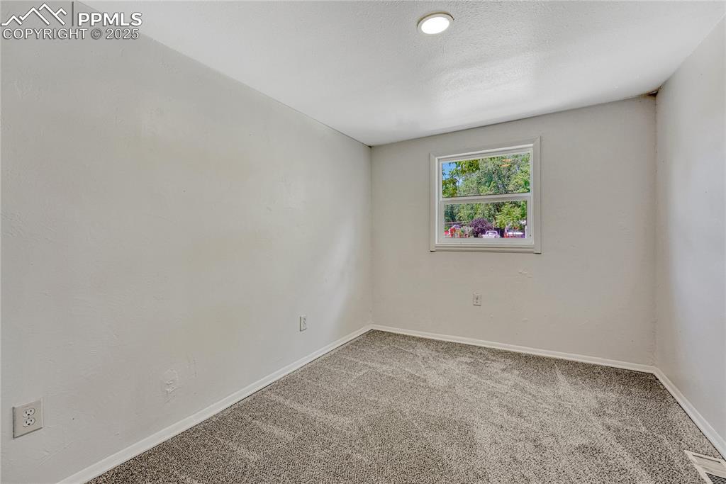 Image 13 of 29: Carpeted empty room with baseboards