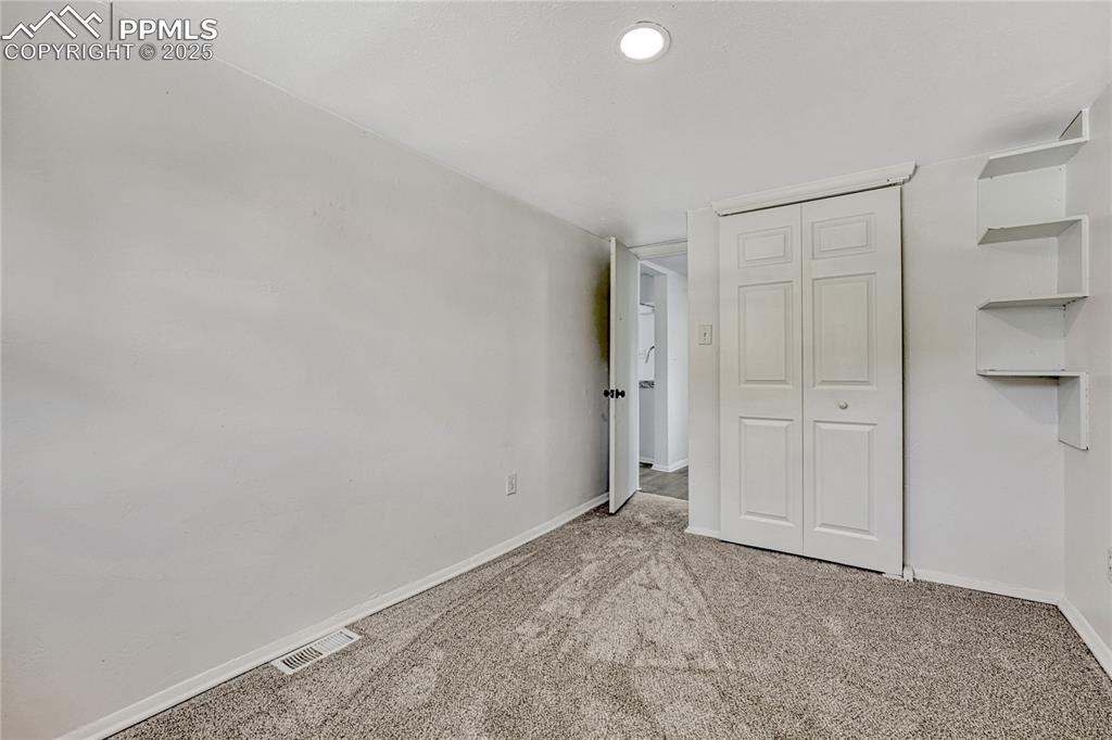 Image 14 of 29: Unfurnished bedroom featuring light carpet and a closet