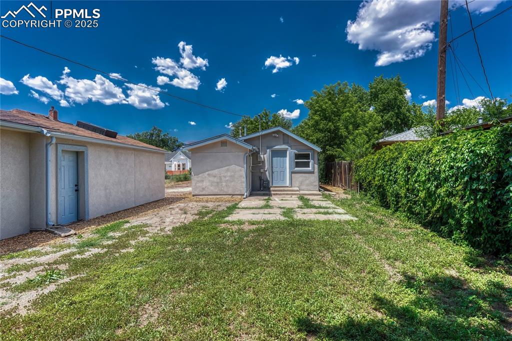 Image 17 of 29: View of yard featuring an outbuilding and entry steps
