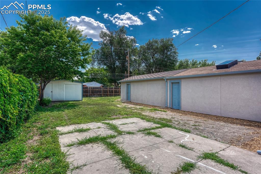 Image 19 of 29: View of yard with a storage shed and a patio