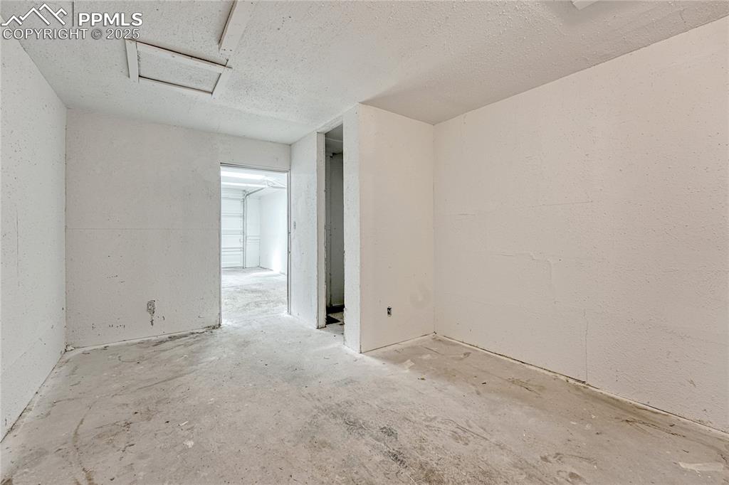 Image 23 of 29: Empty room featuring attic access and a textured ceiling