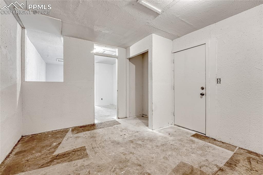 Image 25 of 29: Entryway featuring a textured wall and a textured ceiling