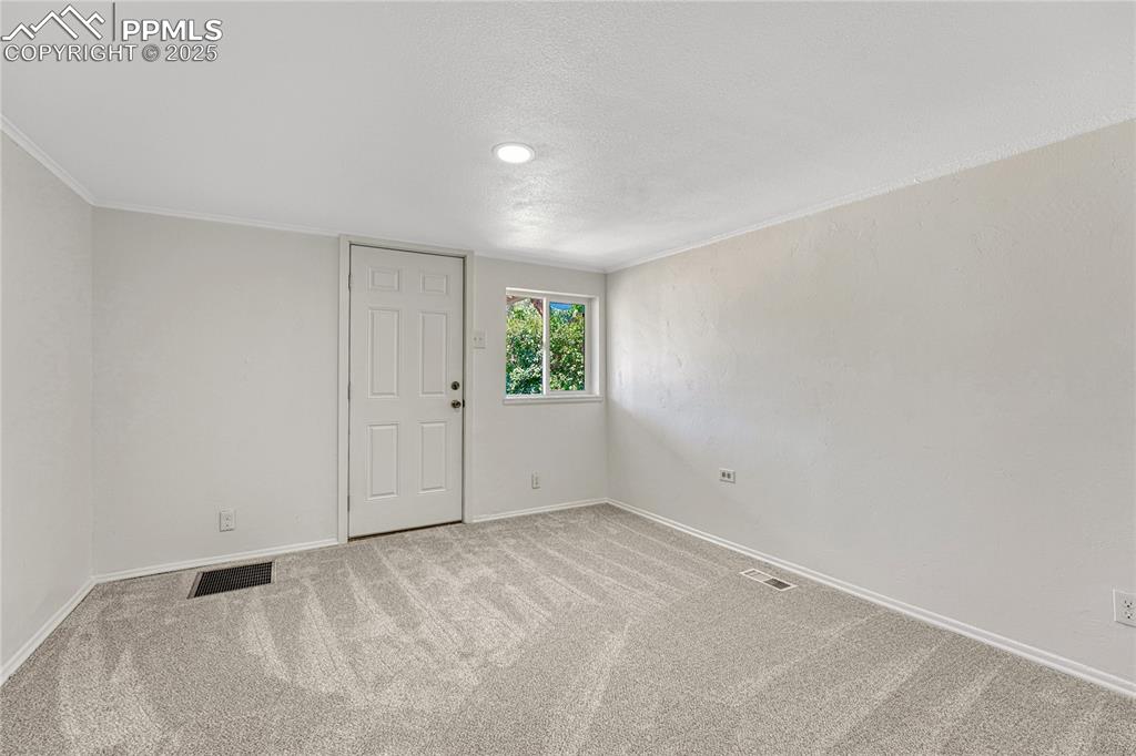 Image 5 of 29: Unfurnished room with carpet flooring and a textured ceiling