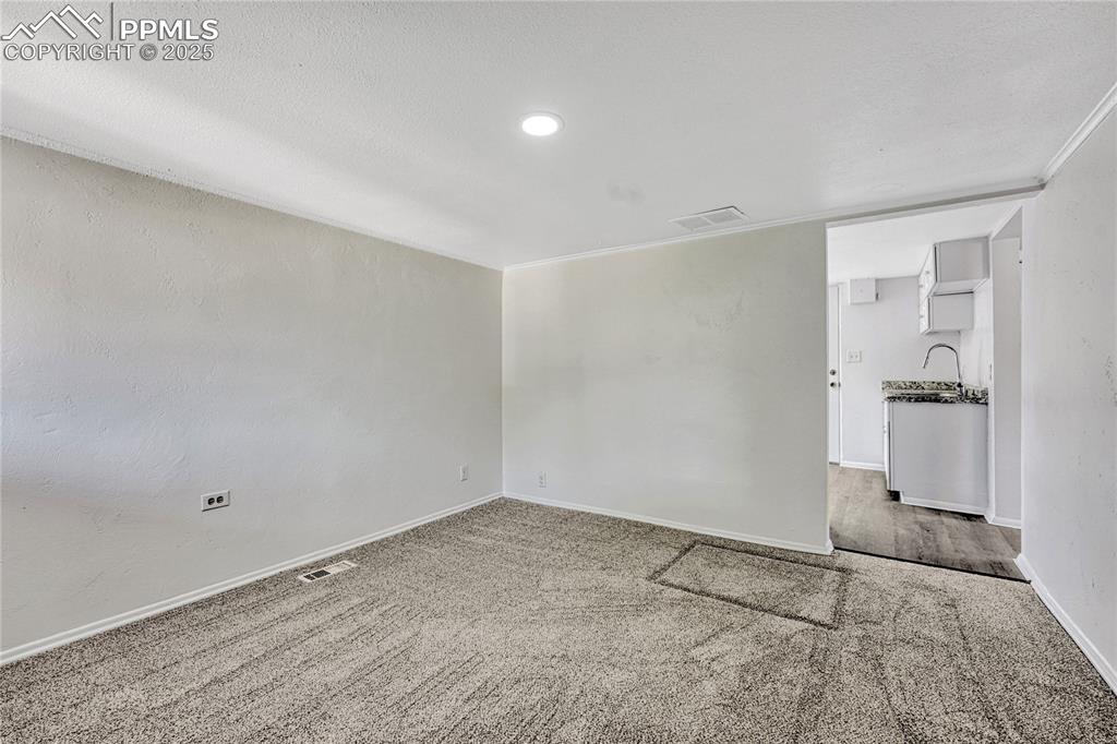 Image 7 of 29: Carpeted empty room with baseboards and crown molding