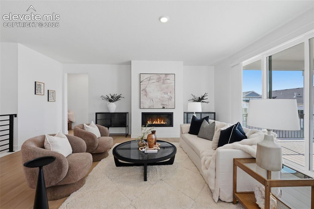 Image 5 of 49: fire place with walk out patio access.