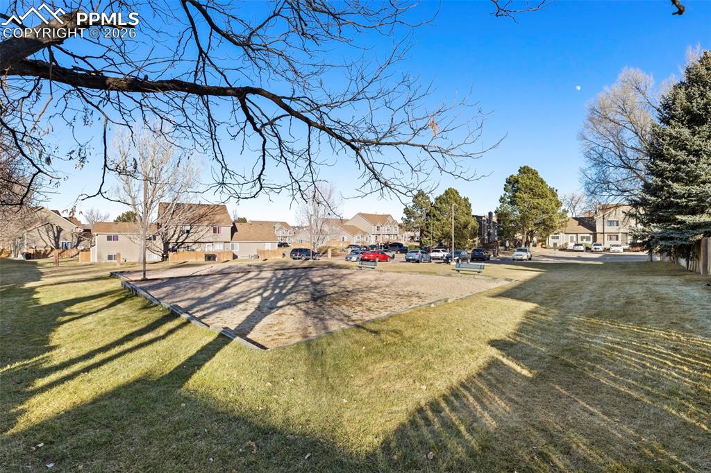 Image 22 of 26: View of grassy open space and park with a residential view