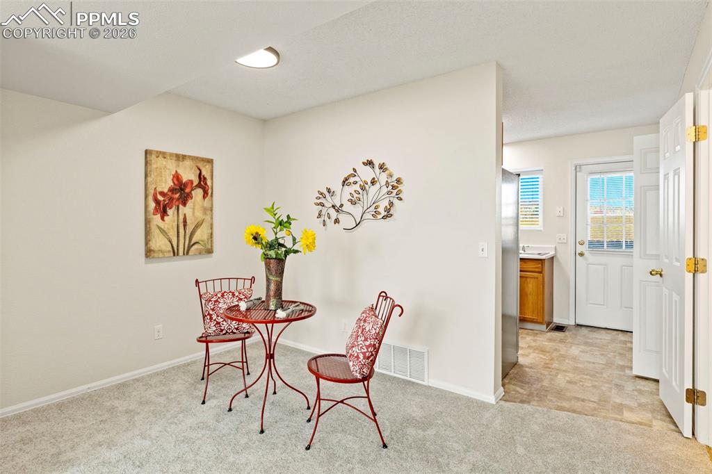 Image 4 of 26: Dining room with light colored carpet