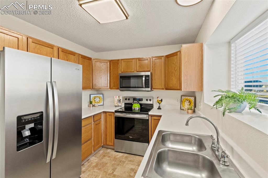 Image 5 of 26: Kitchen with all BRAND-NEW stainless steel appliances, new lighting and bro