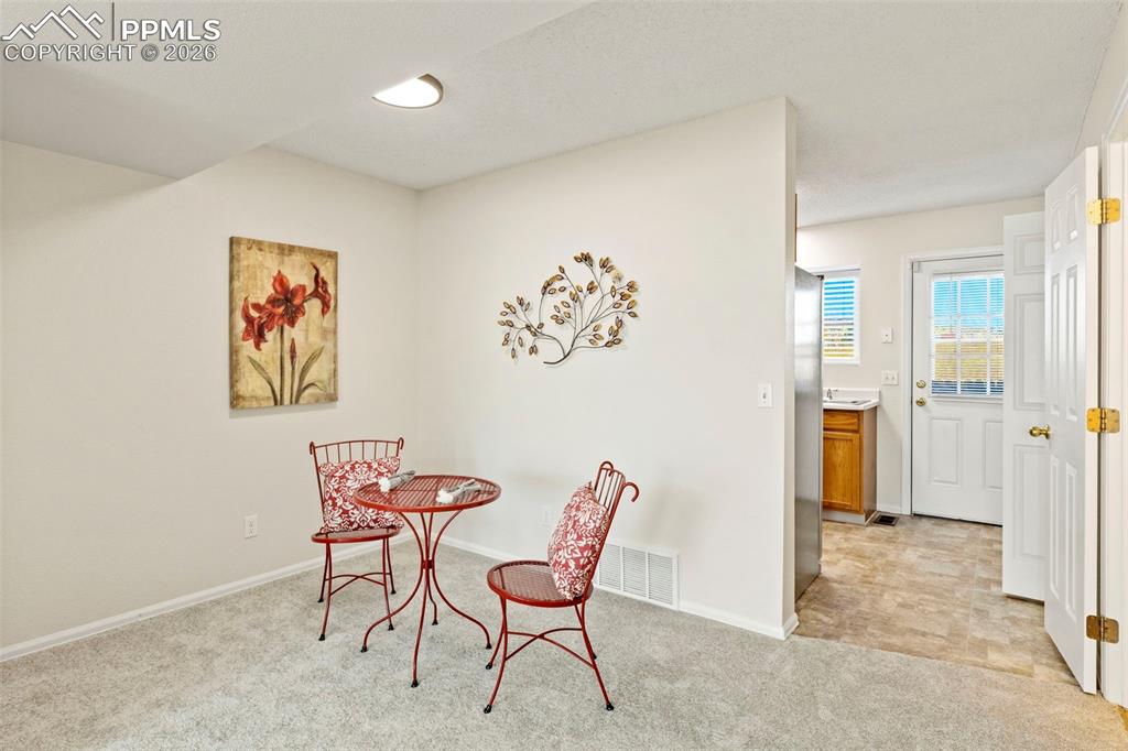 Image 7 of 26: Dining space featuring light colored carpet