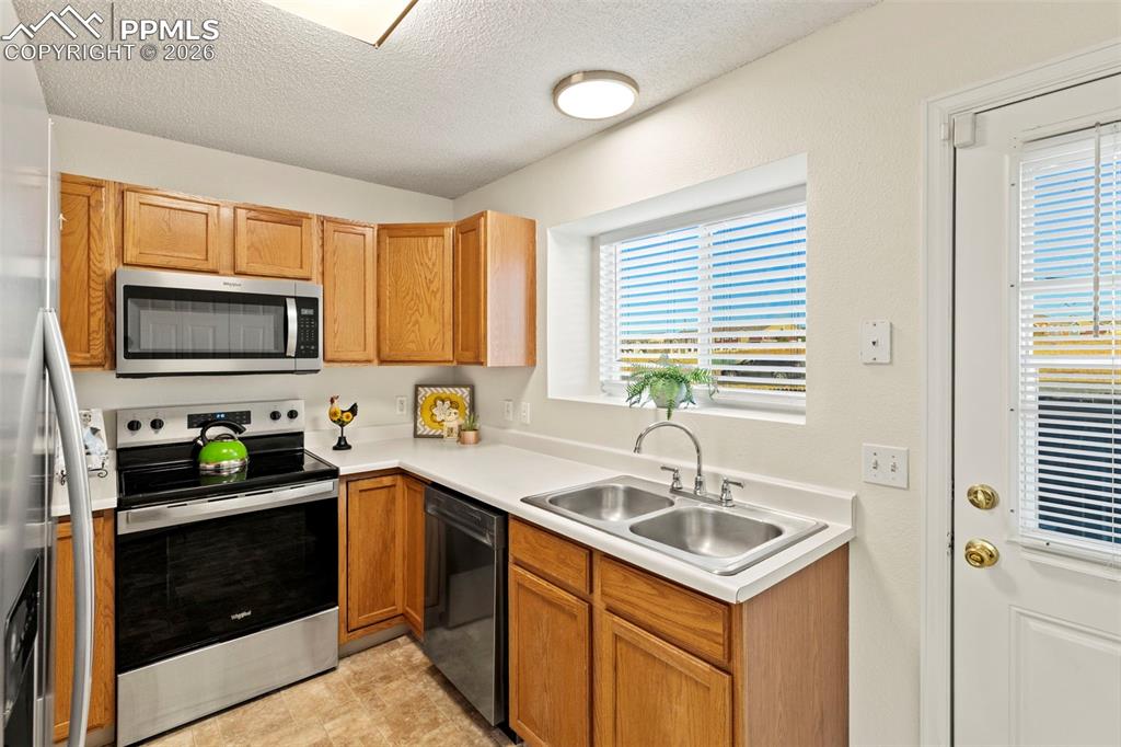 Image 8 of 26: Kitchen opens to fenced private back patio