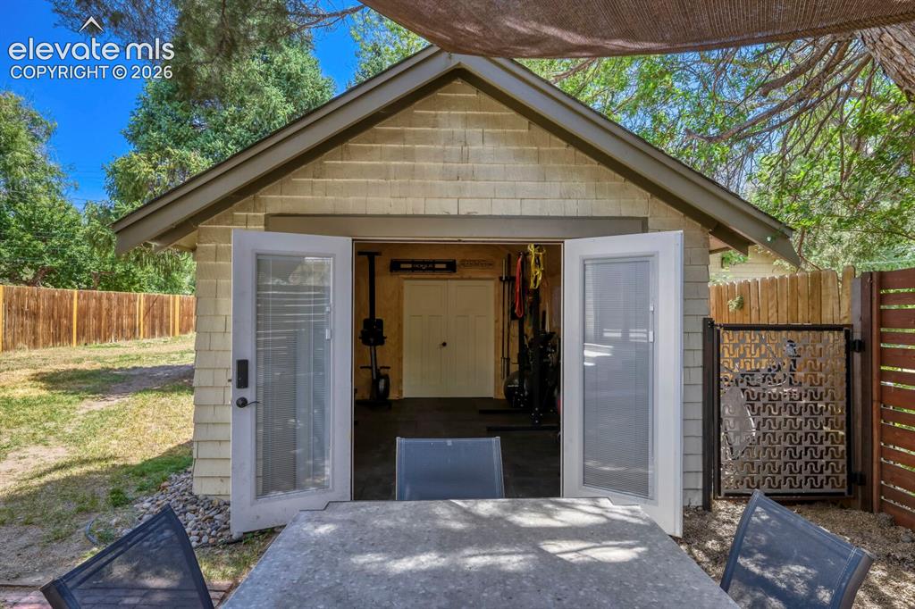 Image 25 of 36: Front entrance to the tandem two car garage, currently converted to a gym,