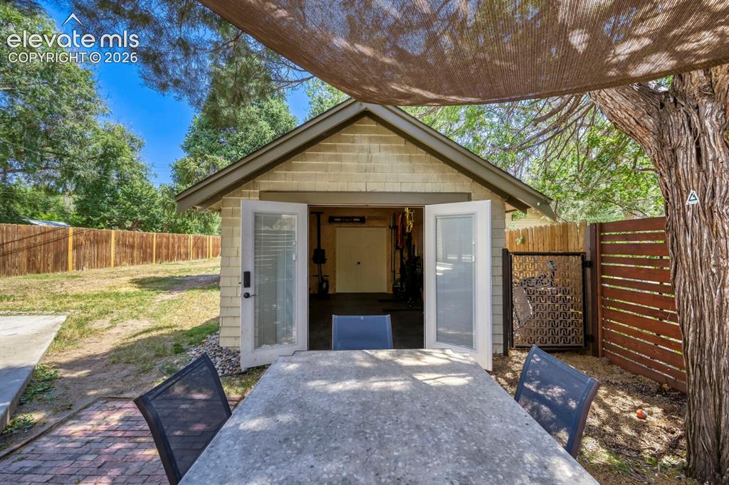Image 26 of 36: Another look to the garage with the patio table area!