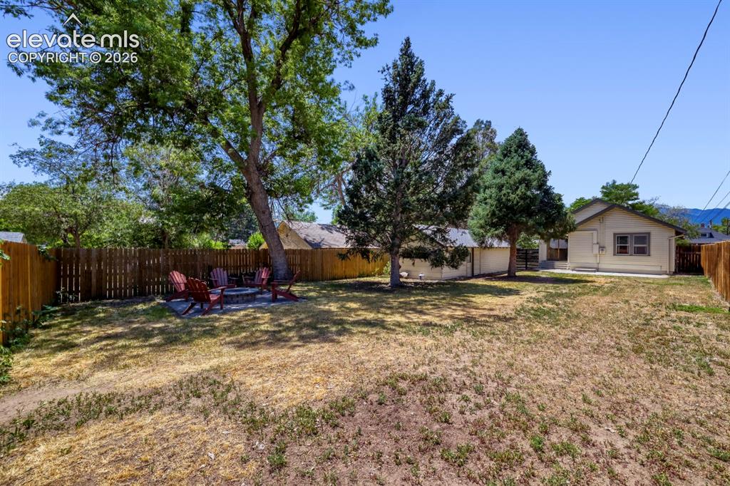 Image 35 of 36: Good look at the rear of the property showing the house, large garage space