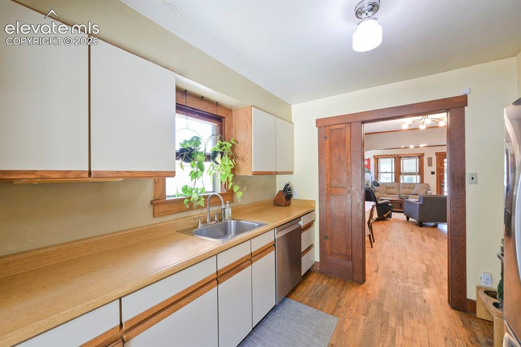 Image 9 of 36: View from the kitchen to the dining room and then living room!