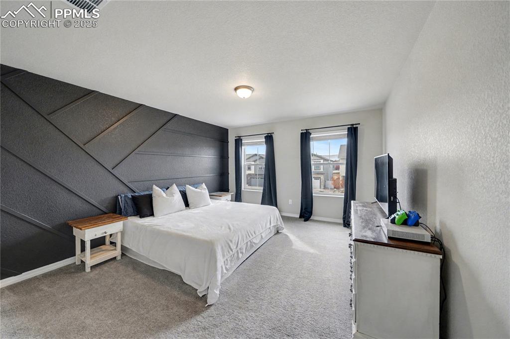 Image 17 of 38: Primary Bedroom with custom accent wall!