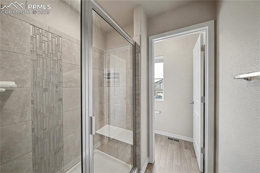 Image 20 of 38: Beautiful walk in shower with upgraded tiling and seat!