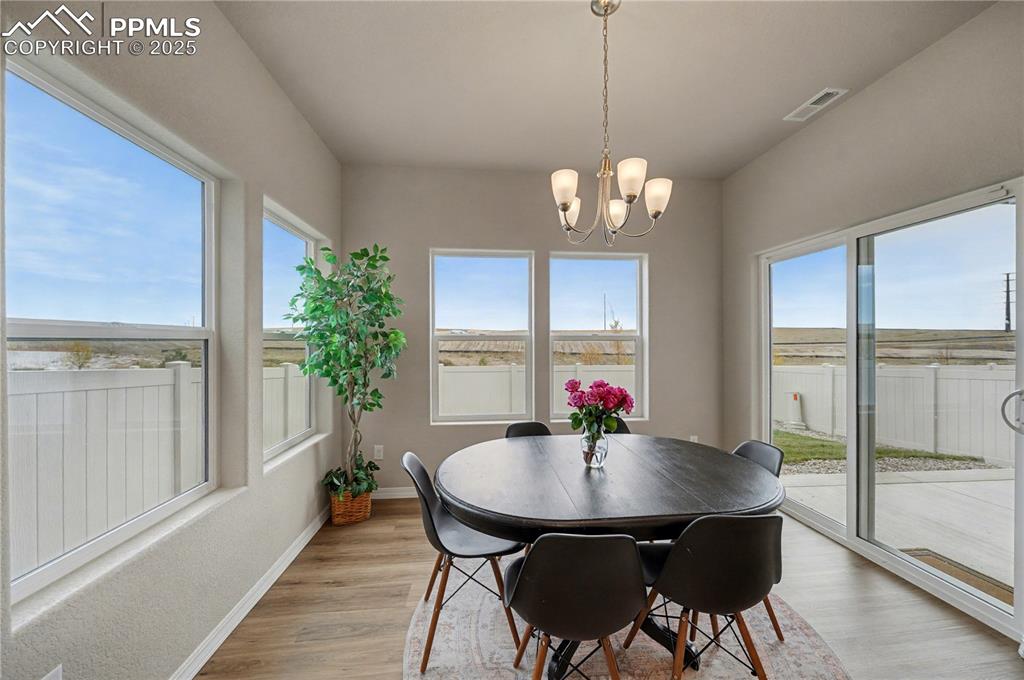 Image 9 of 38: Gorgeous dining area with plenty of windows opening to the yard!