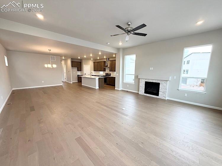 Image 13 of 49: Great room with engineered wood flooring, floor outlet, LED Lighting, ceili
