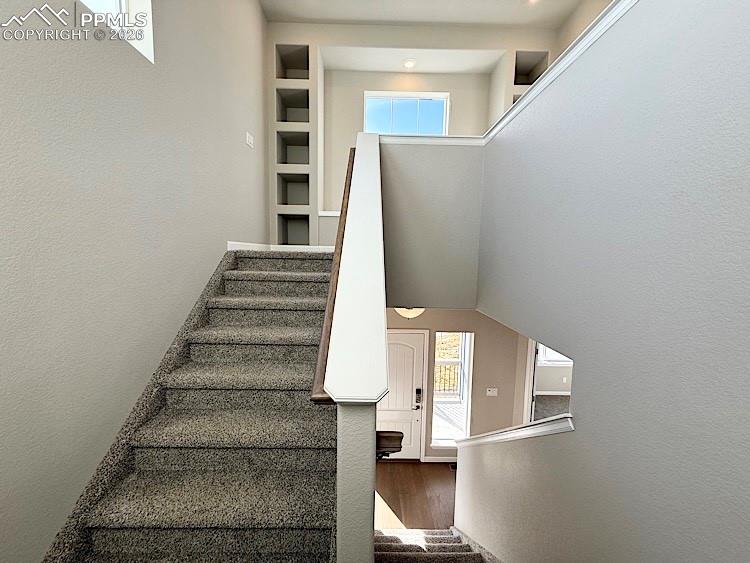 Image 19 of 49: Stairs leading to the upper level.