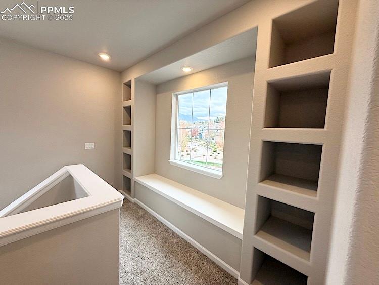 Image 20 of 49: As you step onto the upper level, relax in a cozy sitting nook and take adv