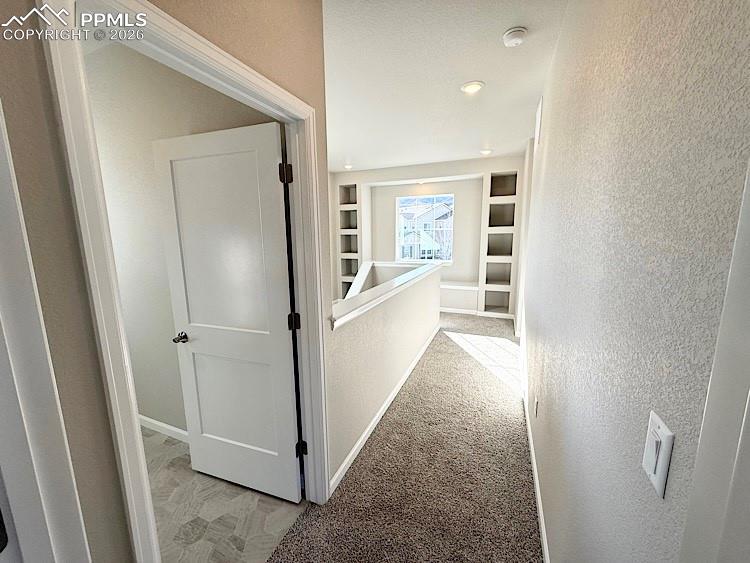 Image 22 of 49: Upper Level Hallway as viewed from the Primary Bedroom. The Laundry Room i