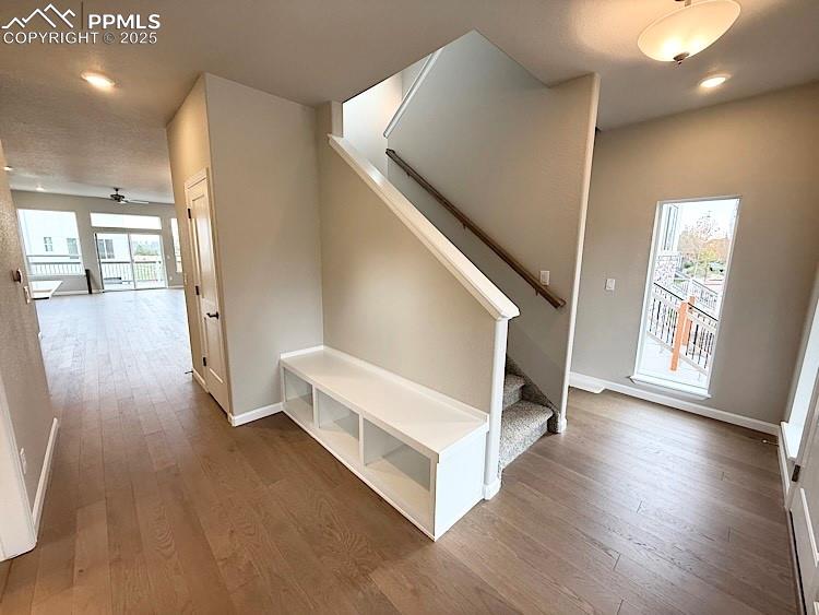 Image 3 of 49: Welcome Home! Inviting entryway with coat closet, bench, natural light, and