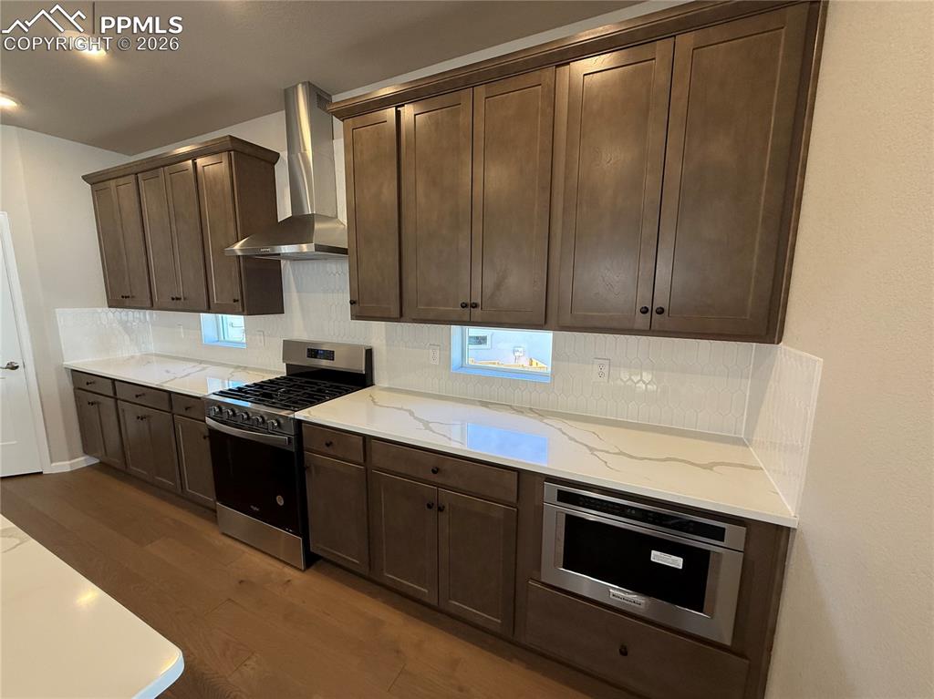 Image 7 of 49: Kitchen with Quartz countertops, pantry, large island providing additional