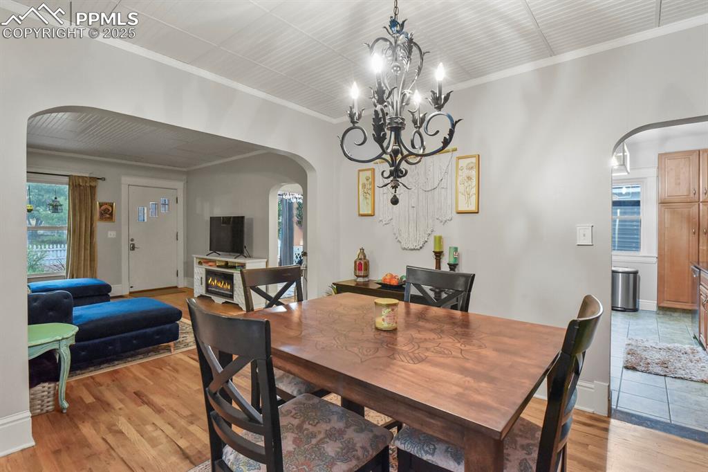 Image 13 of 36: Dining room featuring arched walkways, healthy amount of natural light, cro