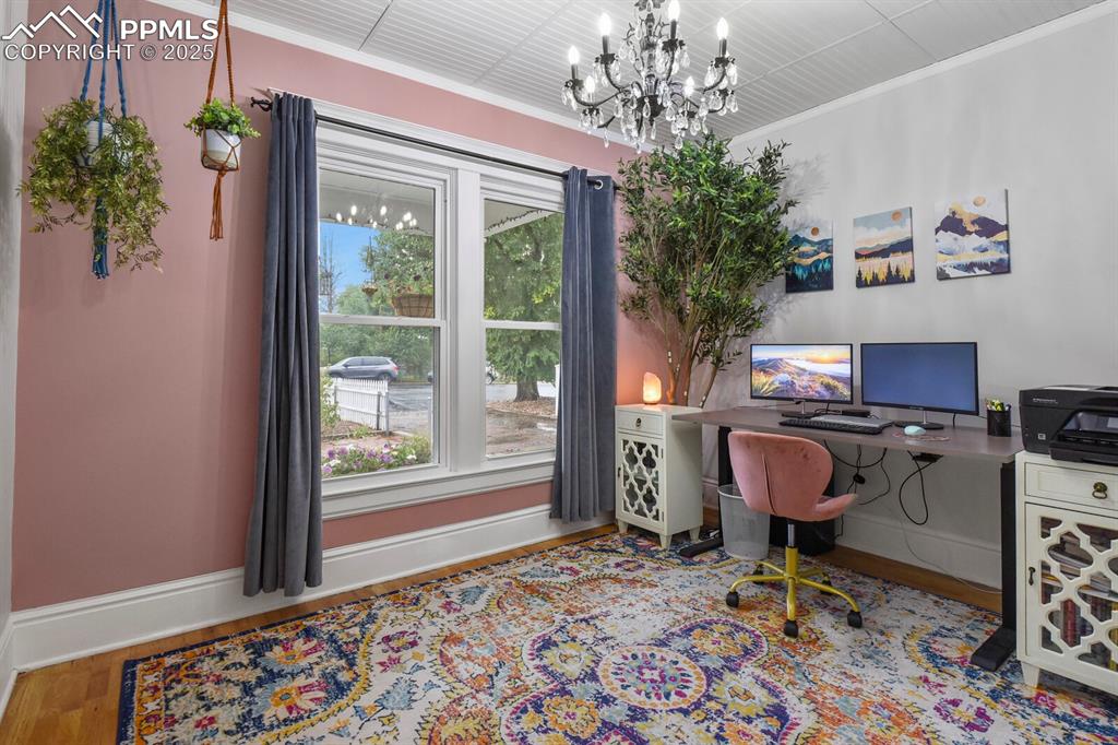Image 14 of 36: Office space featuring wood finished floors, ornamental molding, and a chan